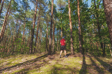 Obraz premium Athlete running on rough terrain in the woods, trail running