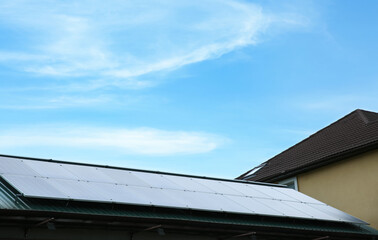 House with installed solar panels on roof. Alternative energy source