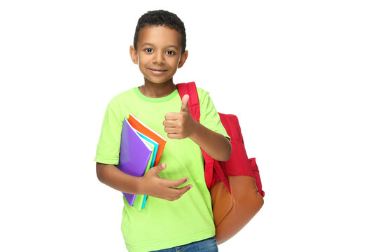 Young African American school boy with notepads and backpack on white background