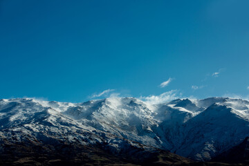 Winter landscape of snow mountain against blue sky in South island, New Zealand.