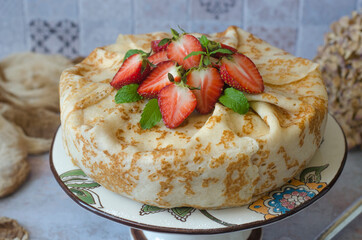 Pancake cake with cream cheese and strawberries