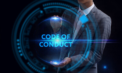 Business, Technology, Internet and network concept. Young businessman working on a virtual screen of the future and sees the inscription: Code of conduct