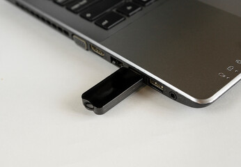 USB stick in laptop on white background