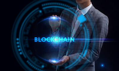 Business, Technology, Internet and network concept. Young businessman working on a virtual screen of the future and sees the inscription: Blockchain