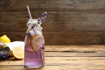 Fresh delicious lemonade with lavender on wooden table. Space for text © New Africa
