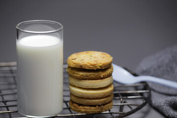 milk and cookies on gray background.