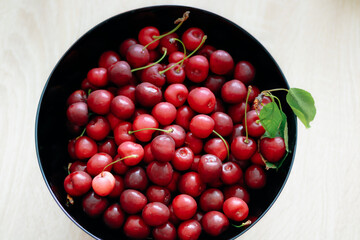 Fresh cherry on black plate on slate background