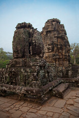 Fototapeta premium Stone murals and sculptures at Bayon Temple in daylight, Angkor Wat, Cambodia