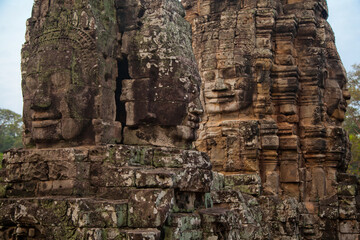 Stone murals and sculptures at Bayon Temple in daylight, Angkor Wat, Cambodia