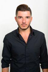 Fototapeta premium Studio shot of handsome bearded Hispanic businessman