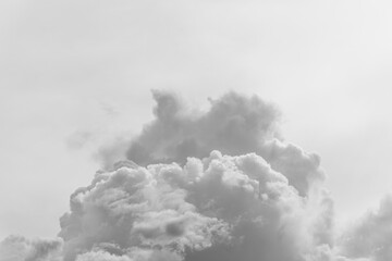 A large cloud in the sky look like smoke from a valcano on a white sky background.