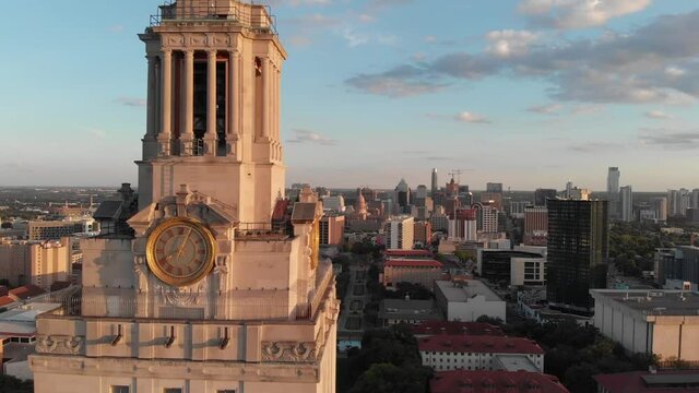 Shot of the top of the UT Tower on campus. Drone flys towards the tower and reveals downtown in the background.