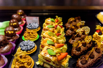Fototapeta na wymiar French pastries with cream, strawberries, chocolate, nuts and wild berries.