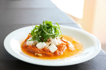 Delicious roasted pepper with feta cheese and arugula on plate