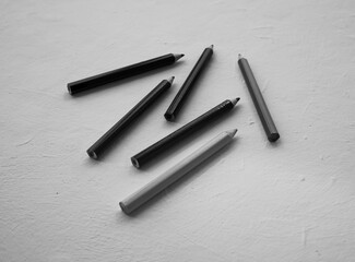 Black and white pencils on a white background, for drawing.