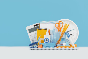 Group of office supplies and school yellow and blue stationery on desk. Banner for back to school...