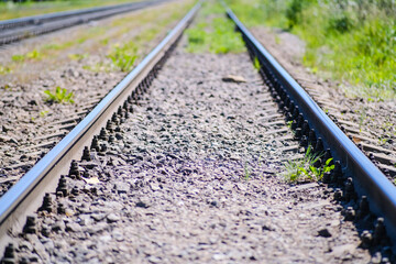 Railway tracks and freight cars. The rails go into the horizon.