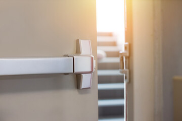 Emergency fire exit door. Closed up latch and rusty door handle of emergency exit. Push bar and...