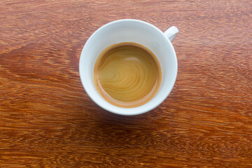 Delicious morning cup of espresso coffee with a beautiful thick crema. A cup of freshly made coffee with a thick crema  on a dark surface. espresso coffee with thick crema , black coffee