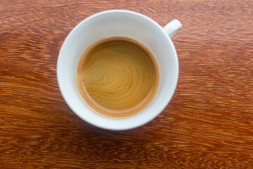 Delicious morning cup of espresso coffee with a beautiful thick crema. A cup of freshly made coffee with a thick crema  on a dark surface. espresso coffee with thick crema , black coffee
