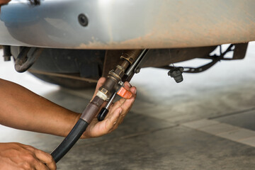 Auto refuel. Car at gas station being filled with fuel. The car is filling LPG with nozzles, Liquid Petroleum Gas service pump. Alternative energy concept. Filling LPG to Car