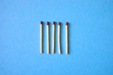 Group of wooden matches on blue background. Business Concept, social distancing concept covid-19.