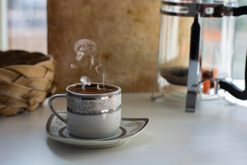hot turkish coffee cup on wood table in front of window