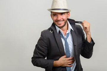 Portrait of handsome bearded Hispanic businessman wearing hat