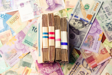 men's hand holds a wad of money