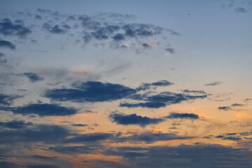 Obraz premium The sky at sunset. Cumulus clouds lit by the rays of the setting sun.