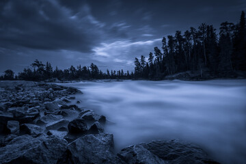 A waterfall on a moonlit night in Northwest Ontario, Canada.