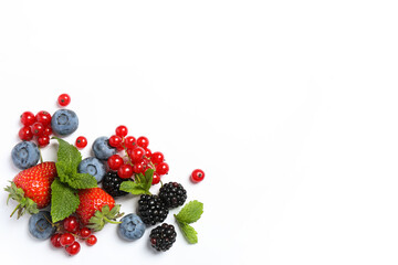 Mix of fresh berries on white background, flat lay