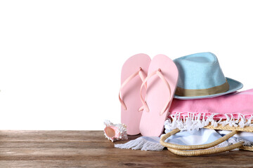 Different beach objects on wooden table against white background. Space for text