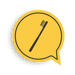 Black Toothbrush icon isolated on white background. Yellow speech bubble symbol. Vector.