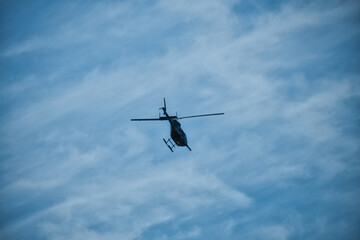 the helicopter in the clouds on a sunny summer day