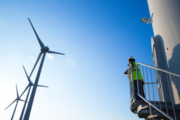 Engineers working on wind turbine in wind farm