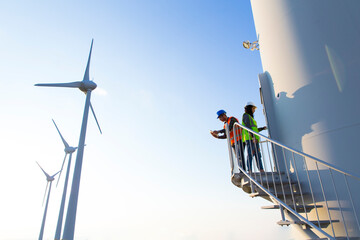 Engineers working on wind turbine in wind farm