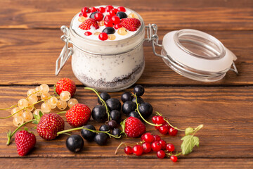 Natural yogurt and berries on a wooden table background. Healthy eating. Diet, weight loss, healthy lifestyle.