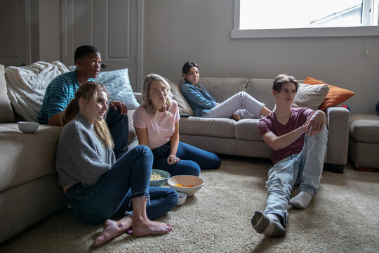 Teen Friends Watching TV In Living Room