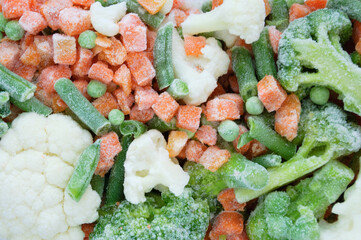 Frozen vegetable mixture green beans, carrots and cabbage close-up.