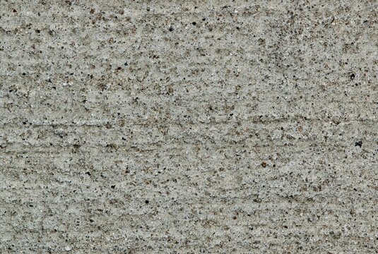 Gritty cement texture background wallpaper, full frame image. Macro details and room for text.