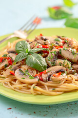 Pasta with mushrooms, sun-dried tomatoes and parsley.