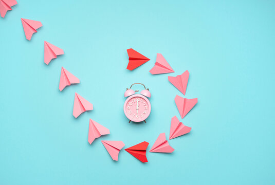Time management concept with a clock and paper airplanes. Time flies concept, top view