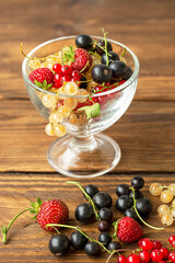 Different berries on a wooden table background. Foods rich in vitamins and antioxidants. Healthy lifestyle.