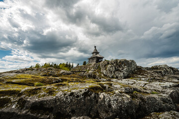 church on the lake. landscape with old wooden church and clouds
