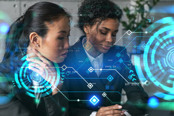 Two businesswomen work together in modern office on new project. Double exposure. Concept of success. Tech hologram.