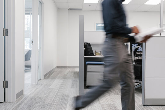 Man walking with documents in office
