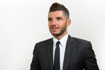 Portrait of handsome bearded Hispanic businessman in suit