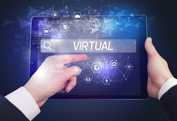 Close-up of a tablet searching VIRTUAL inscription, hi-tech computing concept