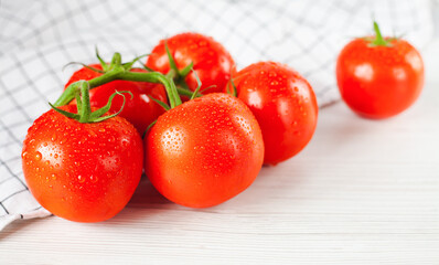 Branch of ripe fresh tomatoes on the table. Close-up. Side view.